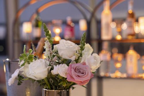 a vase filled with pink and white flowers on a table at The Westin South Coast Plaza, Costa Mesa in Costa Mesa