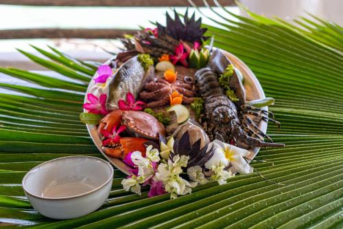 a plate of food on top of a green leaf at Shimoni Reef Lodge in Shimoni
