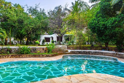 a swimming pool in the backyard of a house at Shimoni Reef Lodge in Shimoni