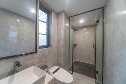 a bathroom with a toilet and a sink and a shower at Lucky Praised Scenery Hotel in Zhangjiajie
