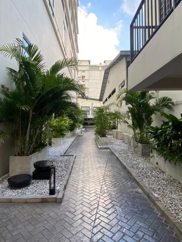 a courtyard of a building with palm trees at SimpleStay Chatuchak, SureStay Collection by Best Western in Bangkok