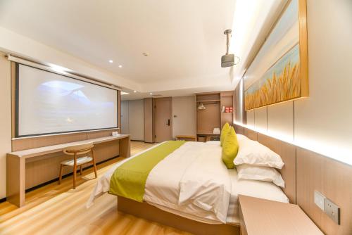 a bedroom with a large bed and a projection screen at Lucky Praised Scenery Hotel in Zhangjiajie