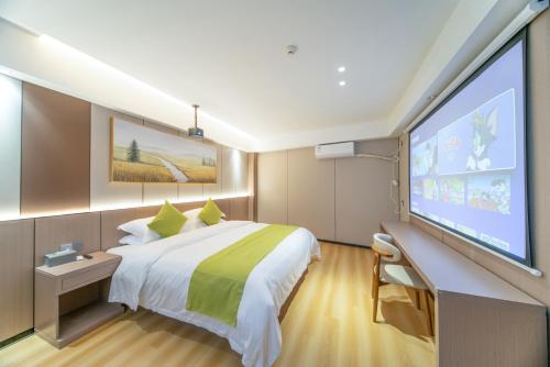 a hotel room with a large bed and a large screen at Lucky Praised Scenery Hotel in Zhangjiajie