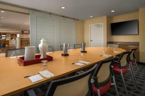 a conference room with a large wooden table and chairs at TownePlace Suites by Marriott Memphis Olive Branch in Olive Branch