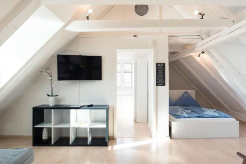 a room with a bed and a table in a attic at HITrental Chapel Bridge Apartments in Luzern