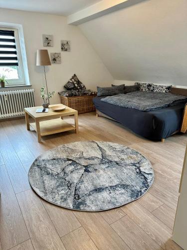 a living room with a bed and a rug at Ferienwohnungen Dörte & Stella Hof Saale in Hof