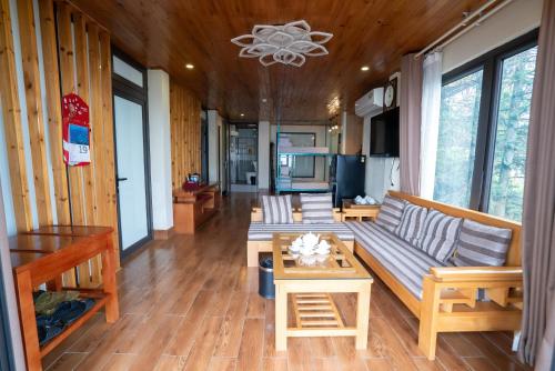 a living room with a couch and a table at SaPa Retreat Condotel in Sa Pa