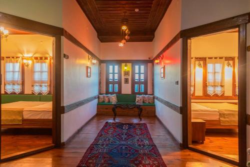 a room with two beds and a rug at Saffronia1900 Butik Otel in Safranbolu