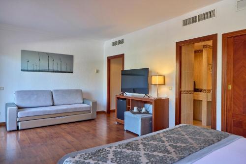 a living room with a couch and a table at Zafiro Rey Don Jaime in Santa Ponsa