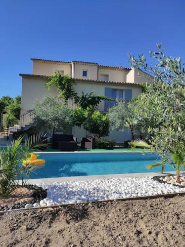 une piscine devant une maison dans l'établissement Maison avec Jardin et Piscine privée, à Nyons