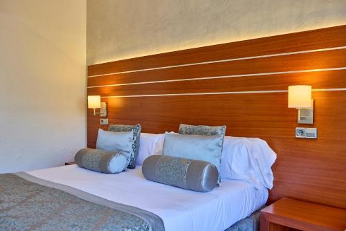 a bed in a hotel room with two pillows on it at Zafiro Rey Don Jaime in Santa Ponsa