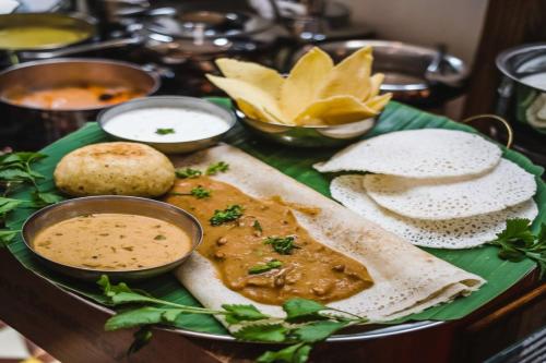 a plate of food on a table with some food at Silvanus Forest Retreat, Alibaug in Alibaug