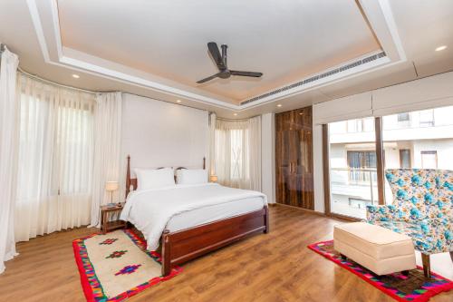 a bedroom with a bed and a couch and a chair at The Manor Luxury Apartments, Shimla in Mashobra