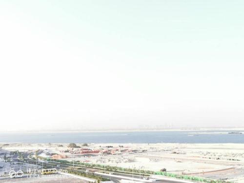 an aerial view of a city and the ocean at Venus saadiyat beach apartment with SeaView in Abu Dhabi