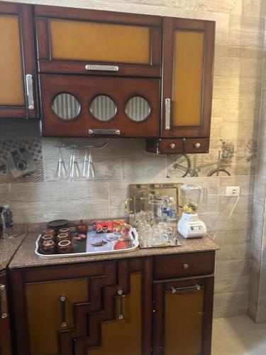 a kitchen with wooden cabinets and a counter top at Karma Kono in Abu Simbel
