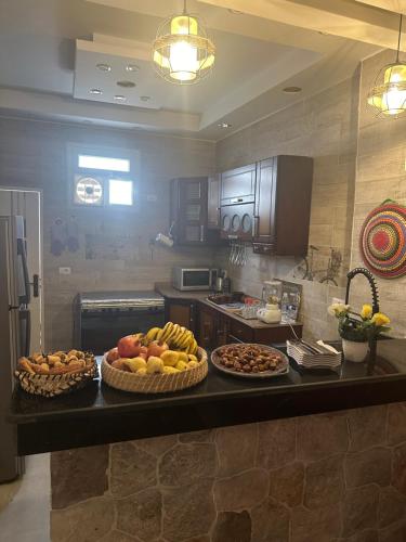a kitchen with two baskets of fruit on a counter at Karma Kono in Abu Simbel