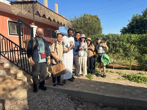 a group of people standing outside of a building at Karma Kono in Abu Simbel