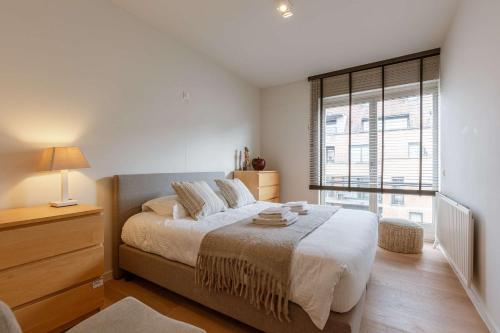 Ένα ή περισσότερα κρεβάτια σε δωμάτιο στο Huswell - Modern apartment close to the beach