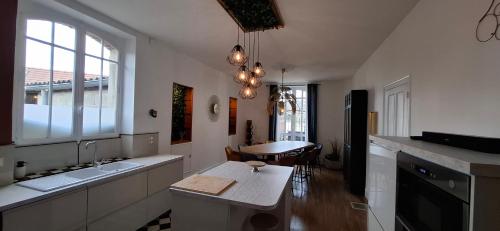 a kitchen with a sink and a table in it at Le Grand Cru in Cramant