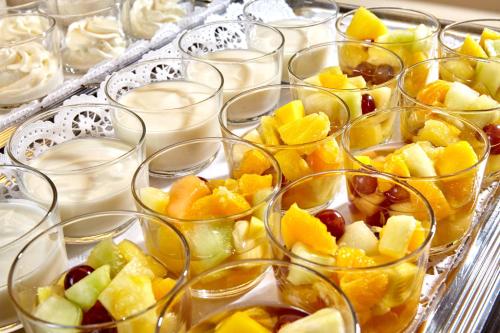 a bunch of glasses filled with fruit in at AURA-HOTEL Saulgrub in Saulgrub