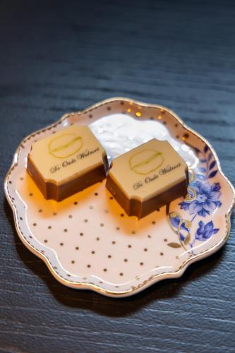 two pieces of chocolate on a plate on a table at De oude walnoot in Sint Pancras