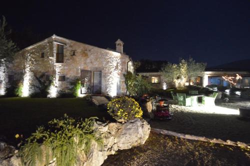 a large stone house at night with lights at Luxury villa Colle dell'Asinello ,proprietari ,Villa In esclusiva near ORVIETO in Guardea