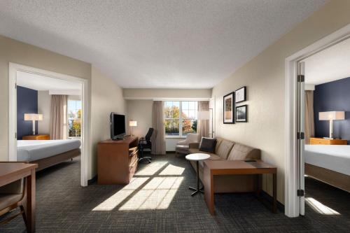 a hotel room with a bed and a living room at Residence Inn Mt. Laurel at Bishop's Gate in Mount Laurel