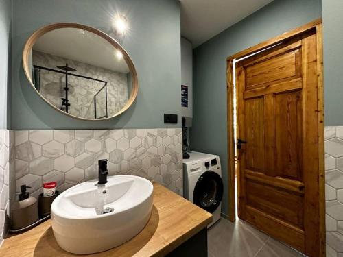a bathroom with a sink and a mirror at 2nd floor Casa Kungu Street in Liepāja