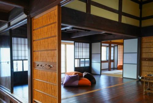 a room with a bed and a wooden floor at Hanakaijichi, Explore the crustal movement every thousand years in Kuroshima