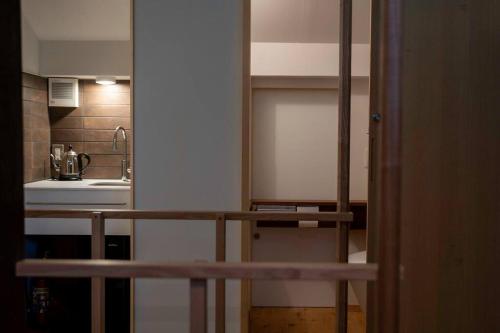 a small kitchen with a sink and a counter in a room at Hanakaijichi, Explore the crustal movement every thousand years in Kuroshima