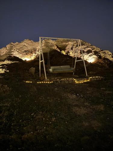 a swing on top of a mountain at night at The Out in Sinādil