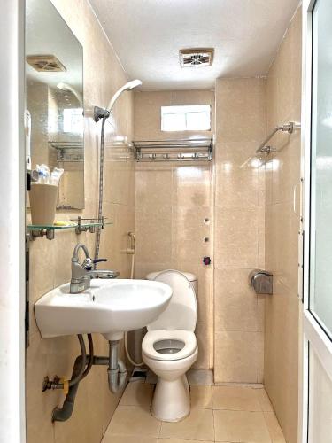 a small bathroom with a sink and a toilet at Frontier Hostel & Tours in Dien Bien Phu