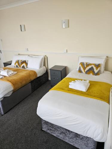 two beds in a hotel room withskirts at The President Hotel in Blackpool