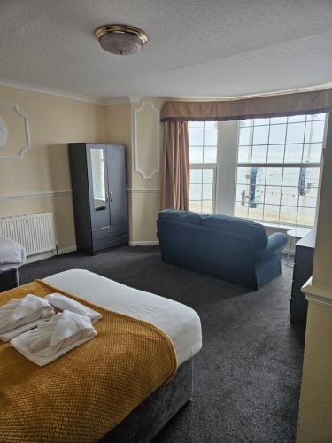 a hotel room with a bed and a couch at The President Hotel in Blackpool