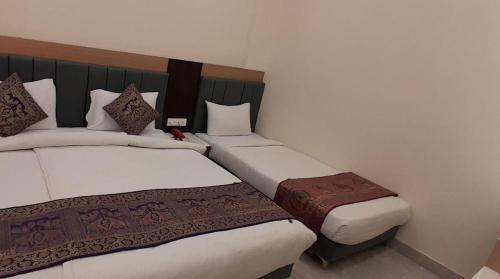 a hotel room with two beds in a room at Hotel Banaras Haveli in Varanasi