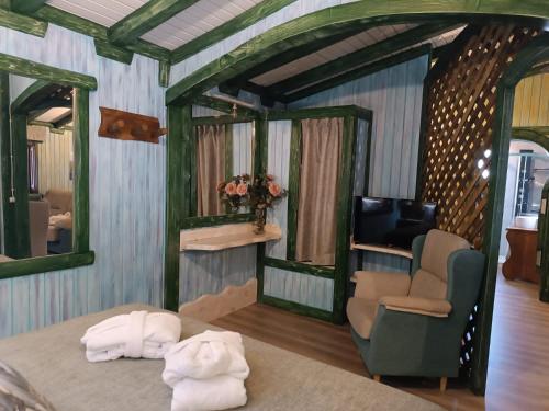 a room with a bed and a chair and a television at El Mirador de la Mancha in Villarrubia de los Ojos