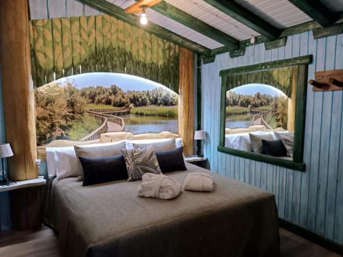a bedroom with a large bed with a large mirror at El Mirador de la Mancha in Villarrubia de los Ojos