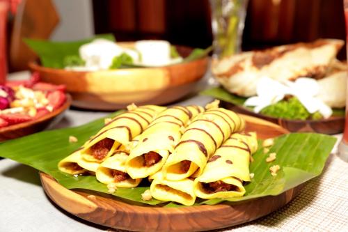 a plate of food sitting on top of a table at The Cattleya Guest House Sigiriya in Sigiriya