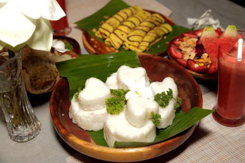 a bowl of food with broccoli on a table at The Cattleya Guest House Sigiriya in Sigiriya