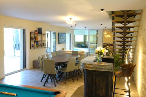une salle à manger et un salon avec une table et des chaises dans l'établissement La Villa des Lys, à Pont-de-Ruan
