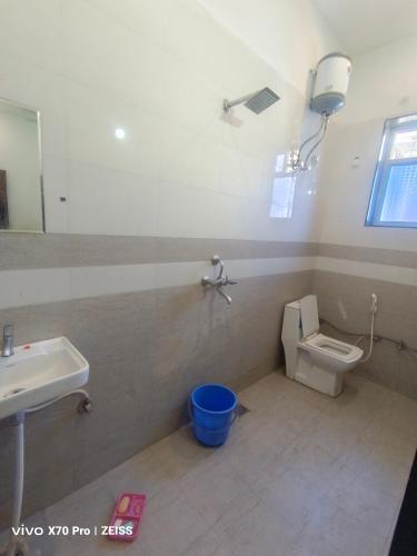 a bathroom with a toilet and a sink at Aasha Place Khatu Shyam ji in Khātu