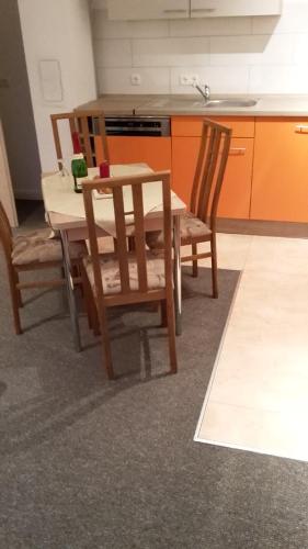 a kitchen with a wooden table and chairs in a room at Pension Lemke in Polchow