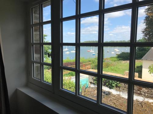 a window with a view of the water at La Grimaudière in La Chapelle-sur-Erdre