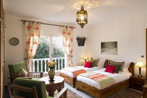 a bedroom with two beds and a window at Villa Quieta in Essaouira