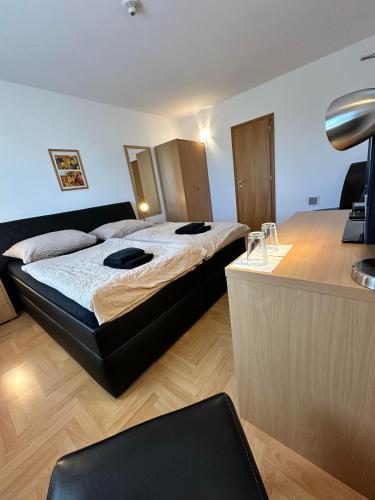 a bedroom with a large bed and a desk at Hotel Muza in Košice