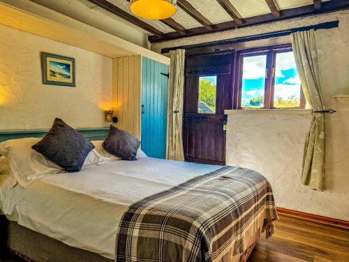 a bedroom with a large bed with a window at Clyne Farm Centre in The Mumbles