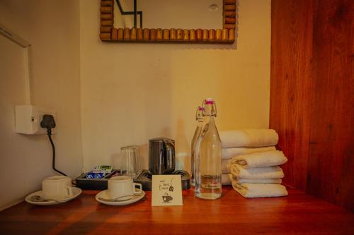 a table with a bottle and some towels on it at Revaant Retreat in Rāmgarh