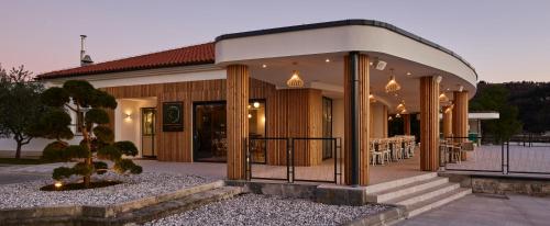 a building with a table in front of it at Holiday Park Vile - Terme Krka in Strunjan