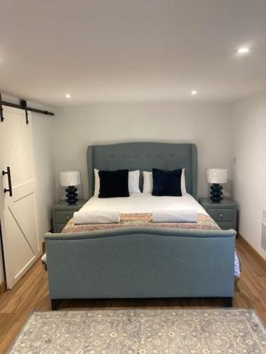 a bedroom with a large bed with two night stands at Wood Lodge in Bungay