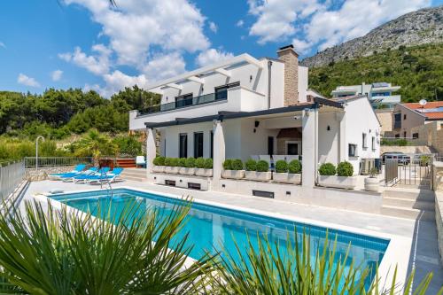 a villa with a swimming pool and a house at Seaview villa Marija in Duće